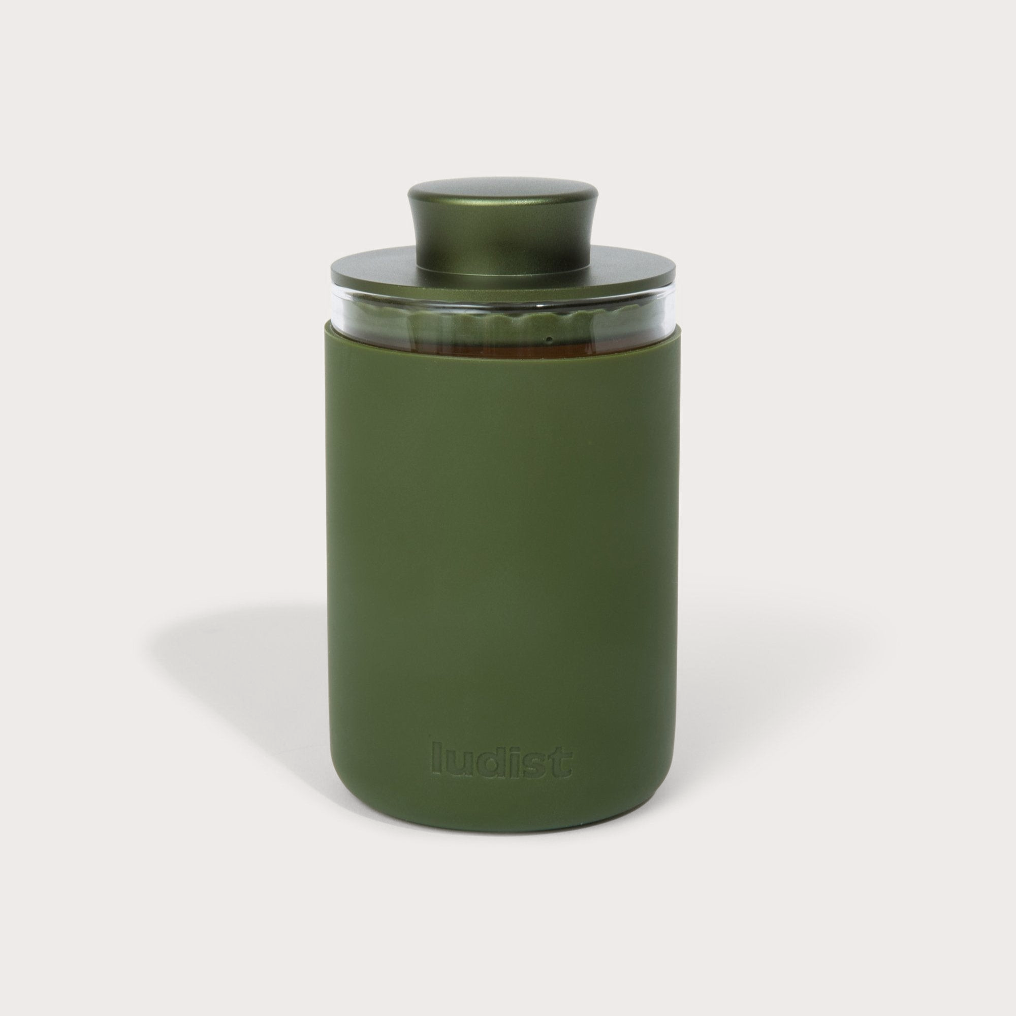 A single green leaf against a white background.