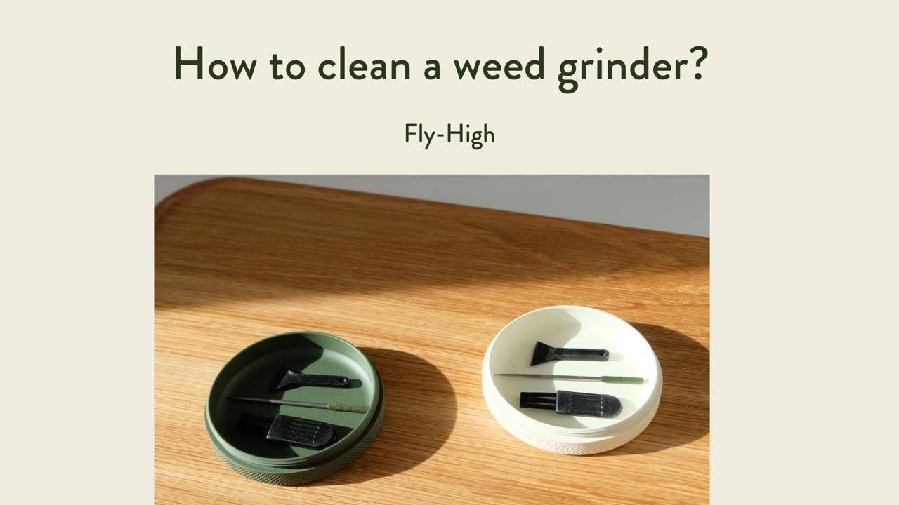 Text reading 'How to clean a weed grinder?' with 'Fly-High' below, displayed above two grinder lids with cleaning tools on a wooden surface.